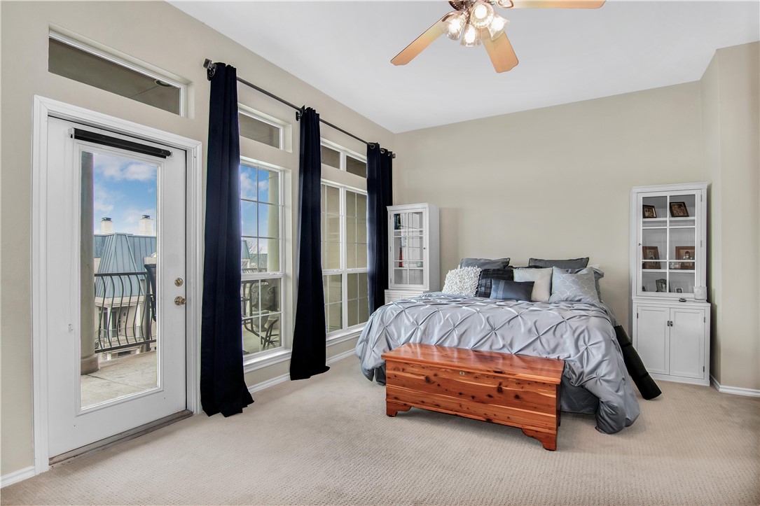 2918 Ranch Road 620 North, Unit W222 Austin, TX 78734 - Photo 17 of 30 a spacious bedroom with a bed and a chandelier