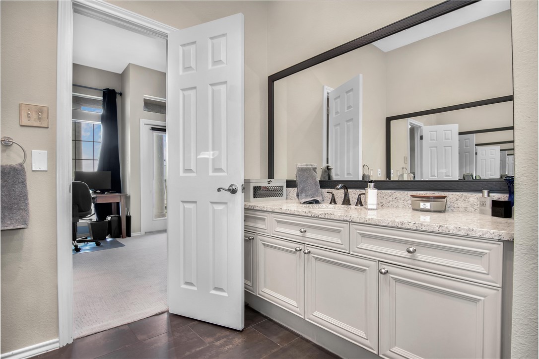 2918 Ranch Road 620 North, Unit W222 Austin, TX 78734 - Photo 21 of 30 a bathroom with a sink vanity and a mirror