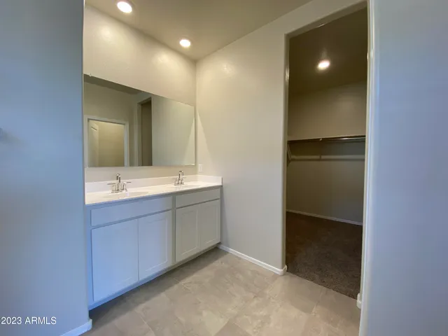 a bathroom with a double vanity sink and mirror