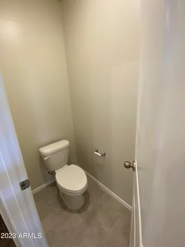 a white toilet sitting next to a shower
