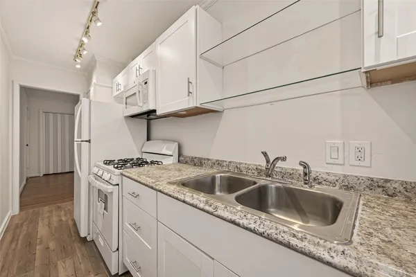 a kitchen with stainless steel appliances granite countertop a sink stove and cabinets