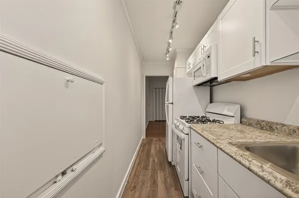 a kitchen with a sink a stove and cabinets