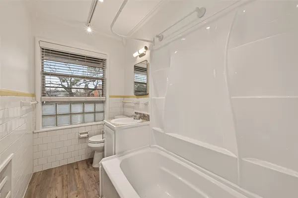 a bathroom with a toilet a sink and bathtub