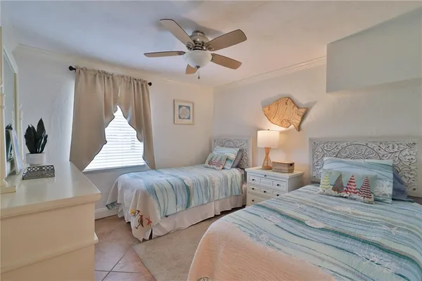 a bedroom with two beds and a table