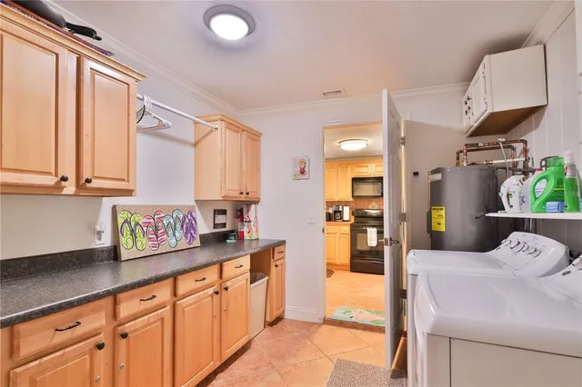 a kitchen with stainless steel appliances kitchen island granite countertop a refrigerator and a sink