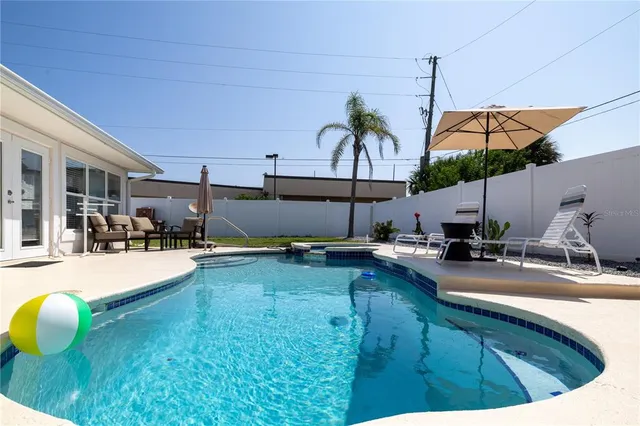 a view of a swimming pool with a patio