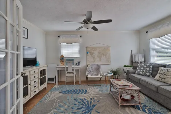 a living room with furniture a rug and a flat screen tv