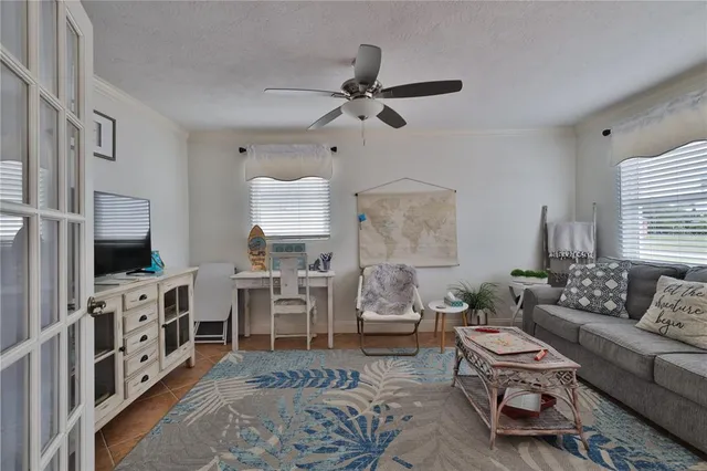 a living room with furniture a rug and a flat screen tv