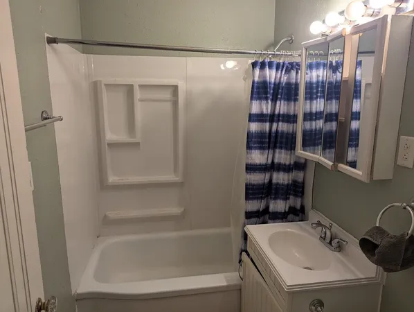 a bathroom with a bathtub and a sink