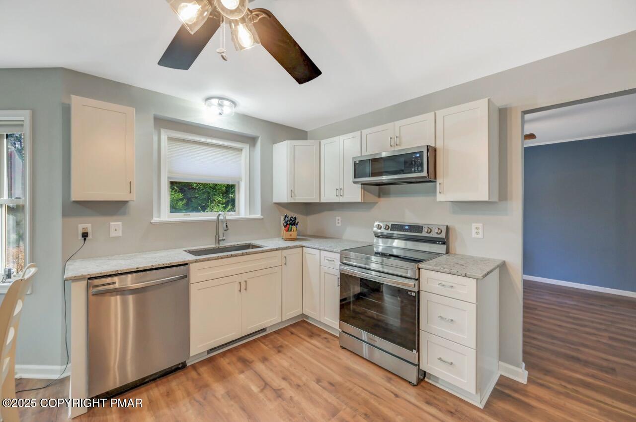 12 Kent Clarke Road Lake Harmony, PA 18624 - Photo 16 of 42 a kitchen with stainless steel appliances granite countertop a sink and cabinets