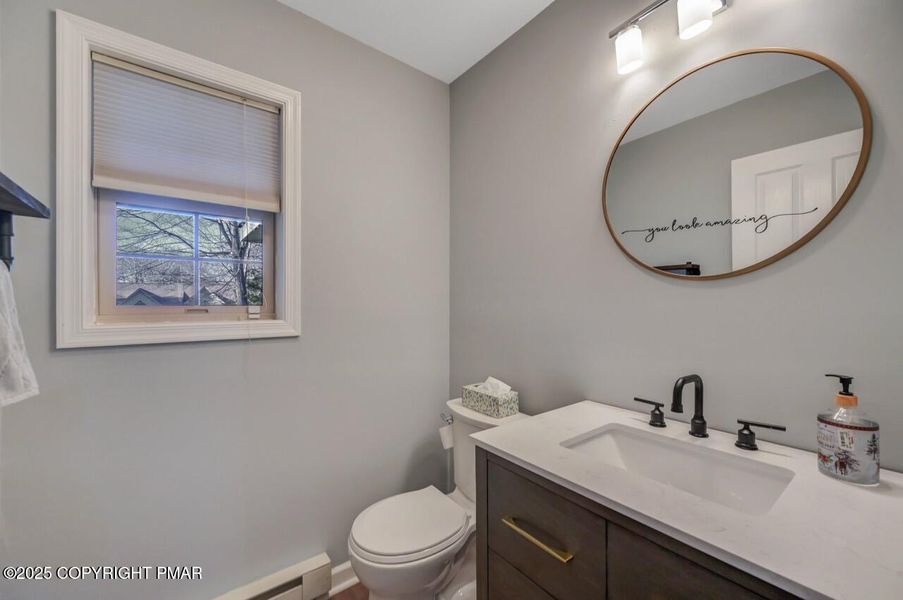 12 Kent Clarke Road Lake Harmony, PA 18624 - Photo 26 of 42 a bathroom with a toilet a sink and mirror