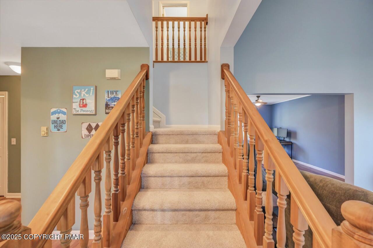 12 Kent Clarke Road Lake Harmony, PA 18624 - Photo 27 of 42 a view of staircase with lots of frames on wall and a large window