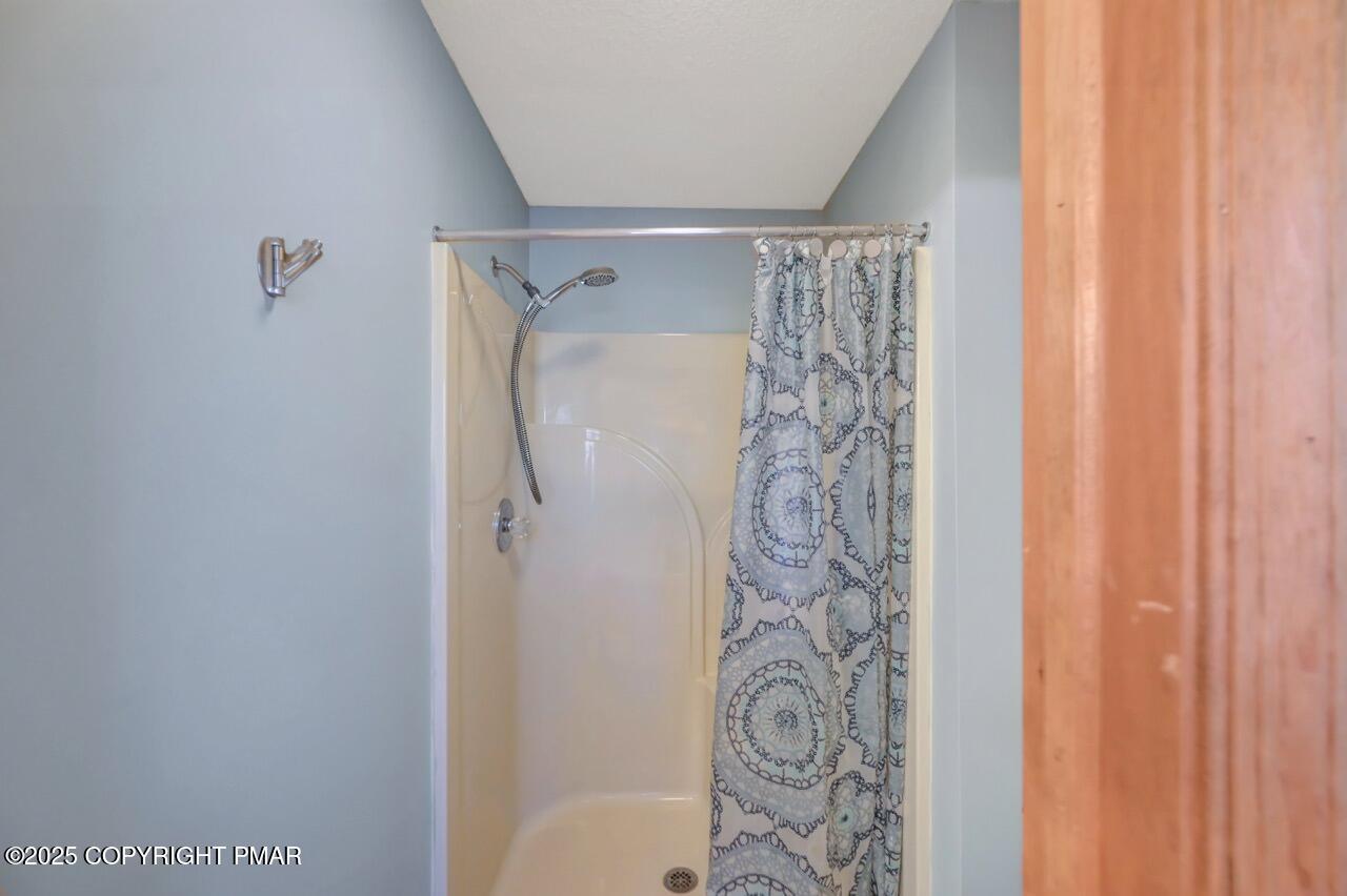 12 Kent Clarke Road Lake Harmony, PA 18624 - Photo 32 of 42 a bathroom with a shower curtain and a curtain