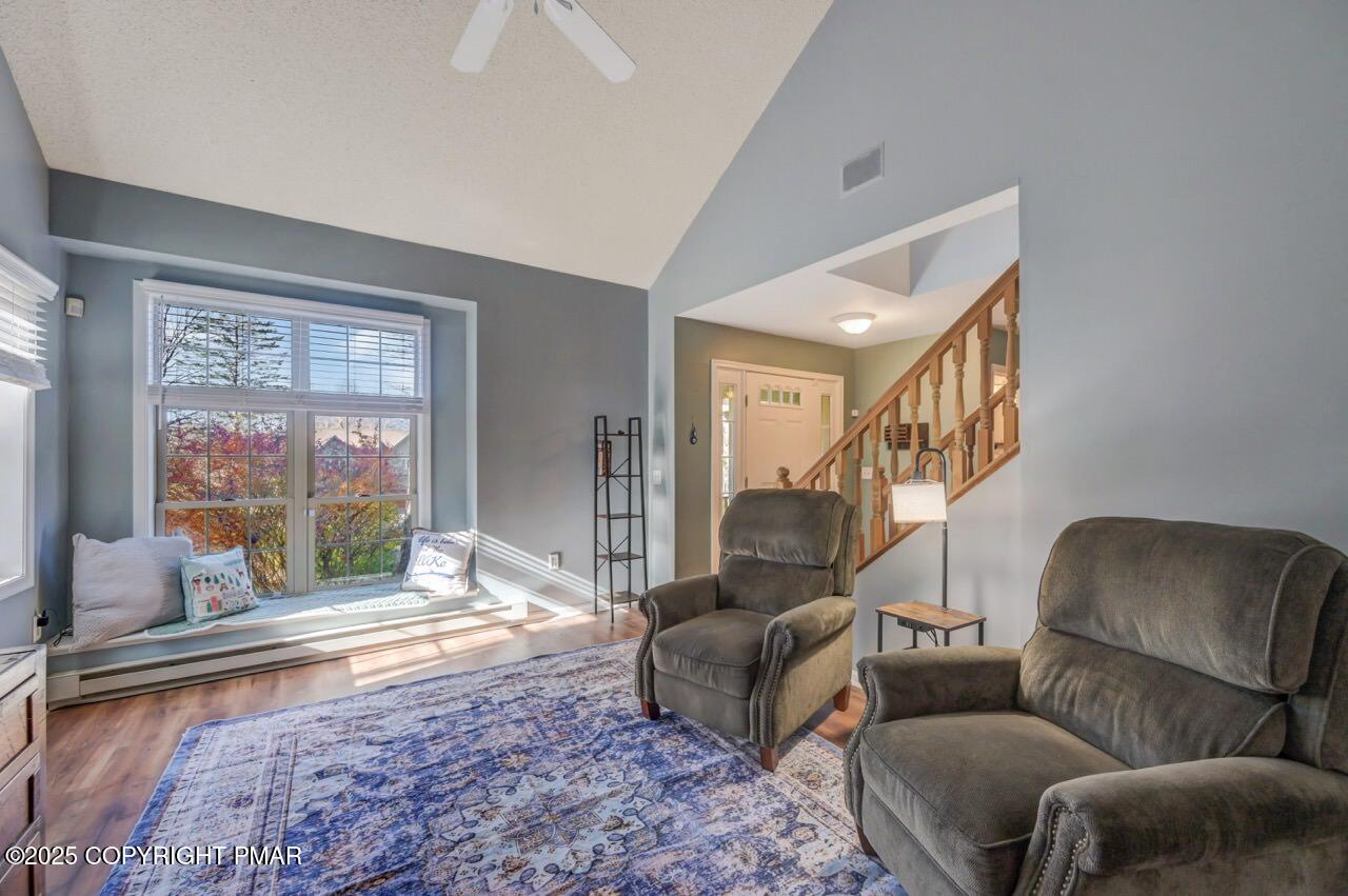 12 Kent Clarke Road Lake Harmony, PA 18624 - Photo 6 of 42 a living room with furniture floor to ceiling window and a flat screen tv