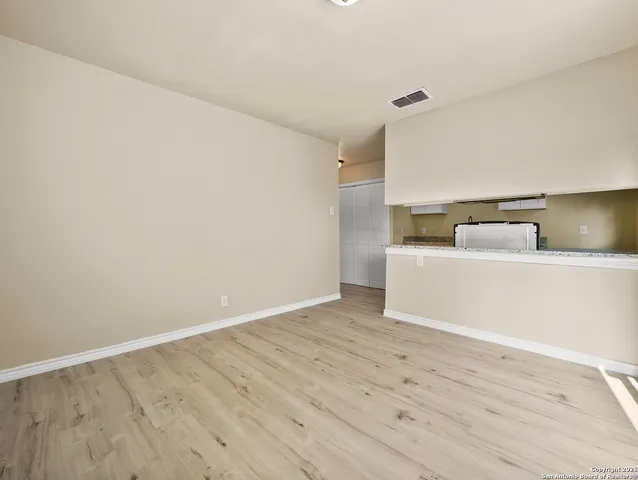 a view of a room with wooden floor