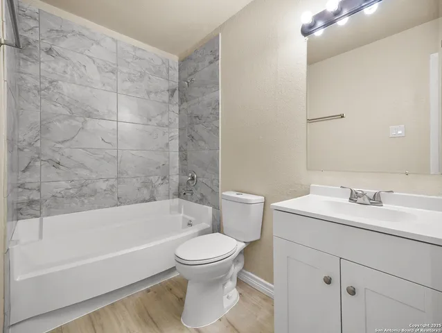 a bathroom with a toilet a sink and bathtub