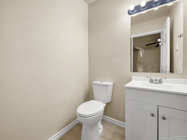 a bathroom with a toilet a sink and mirror