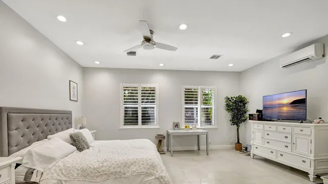 a bedroom with furniture and flat screen tv