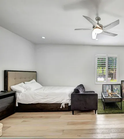 a bedroom with a bed and a window