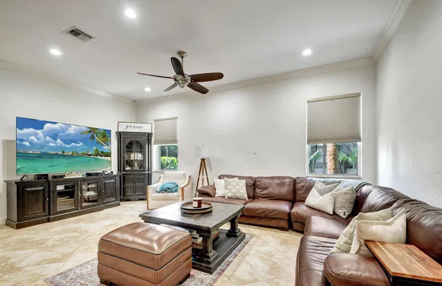 a living room with furniture and a flat screen tv with wooden floor