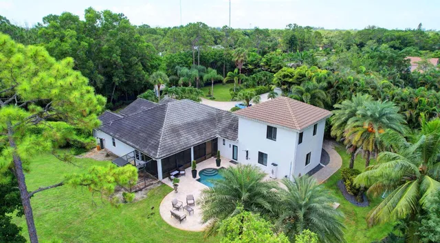 an aerial view of a house with yard table and chairs