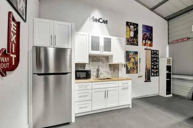 a kitchen with stainless steel appliances a refrigerator sink and cabinets