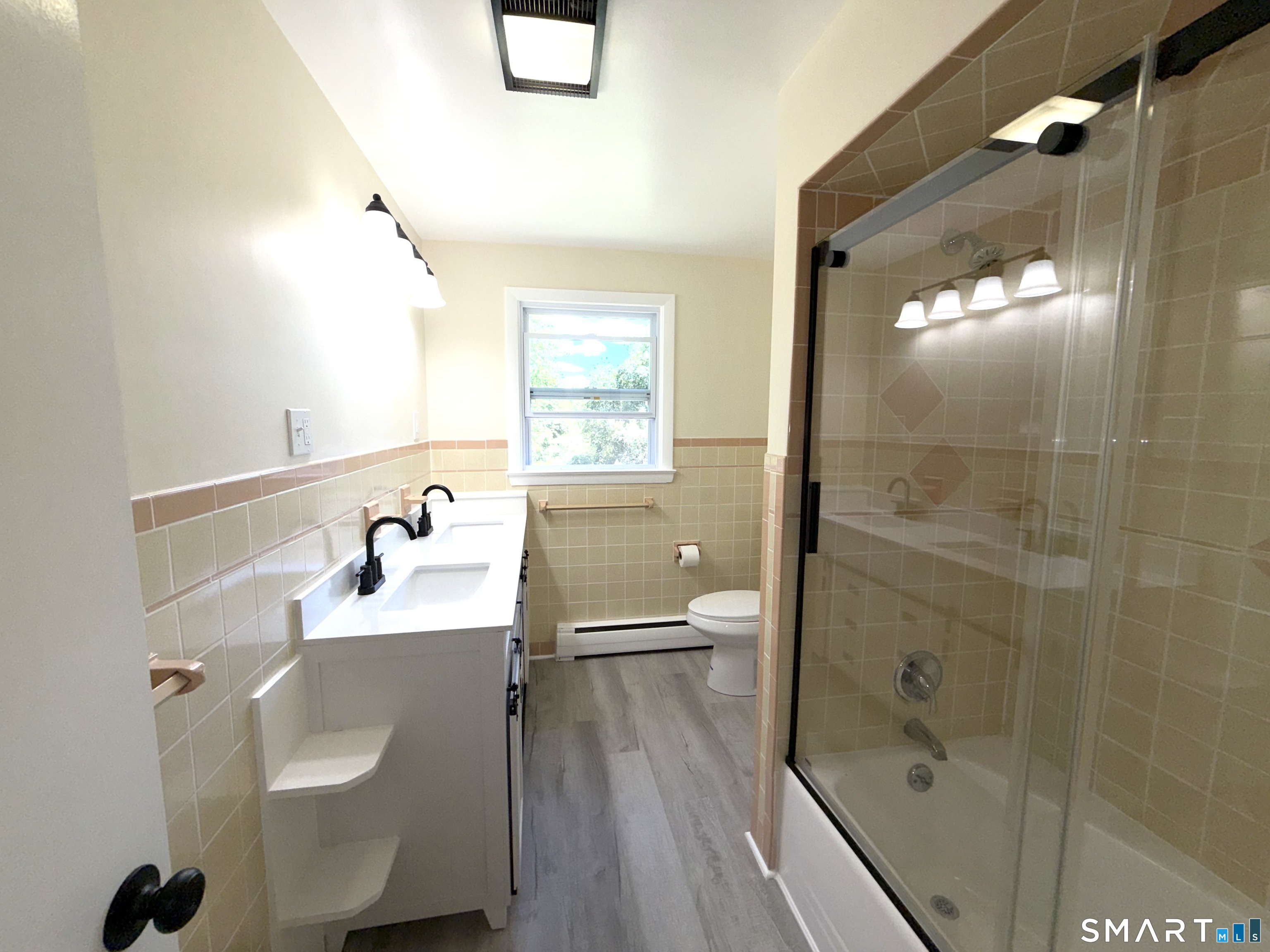 341 Harland Road Norwich, CT 06360 - Photo 18 of 29 a bathroom with a sink a toilet and shower