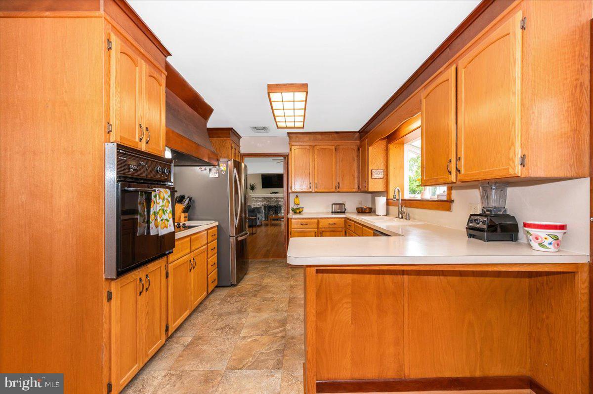22019 Mohawk Drive Smithsburg, MD 21783 - Photo 13 of 60 a kitchen with stainless steel appliances granite countertop a sink and cabinets