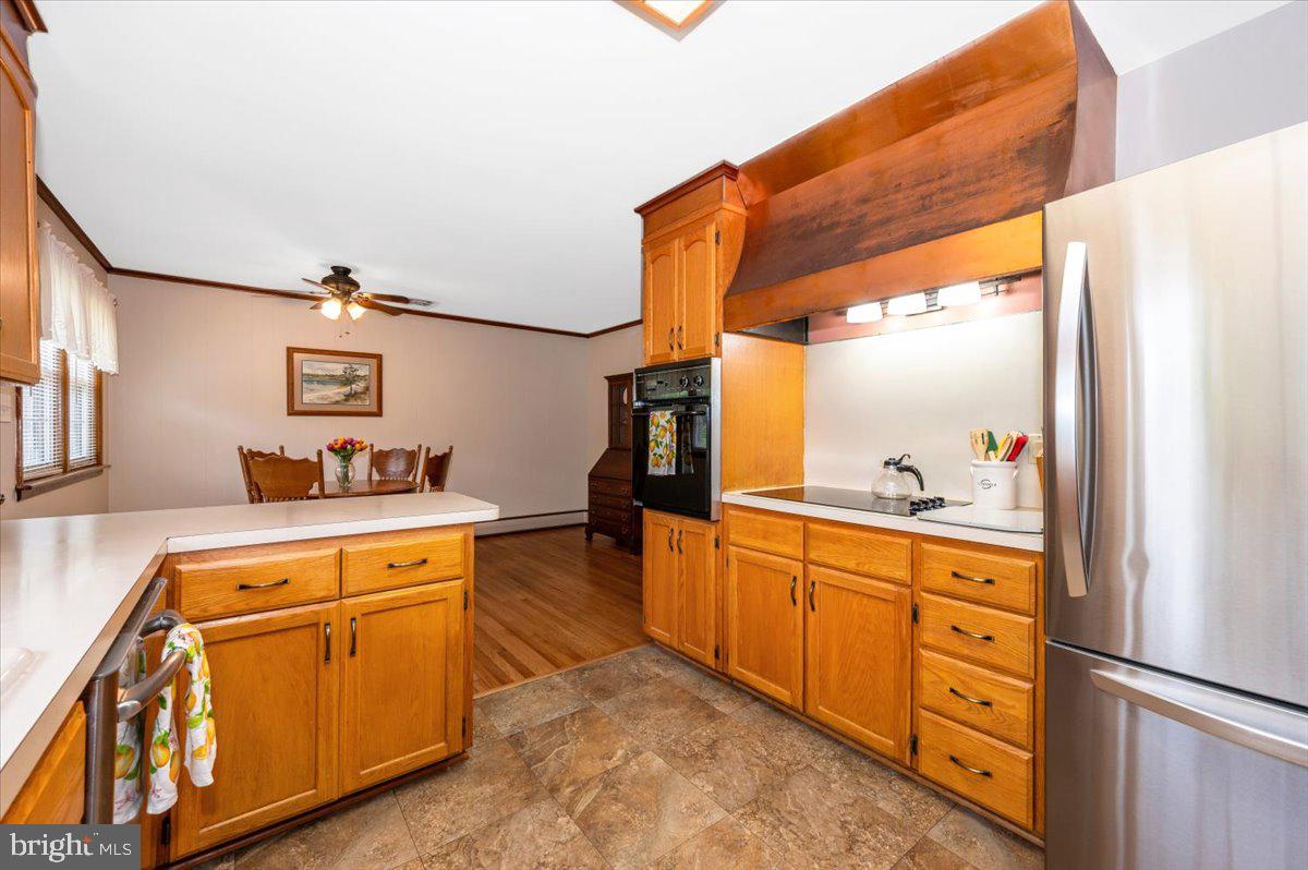 22019 Mohawk Drive Smithsburg, MD 21783 - Photo 17 of 60 a kitchen with stainless steel appliances granite countertop a refrigerator and a stove top oven