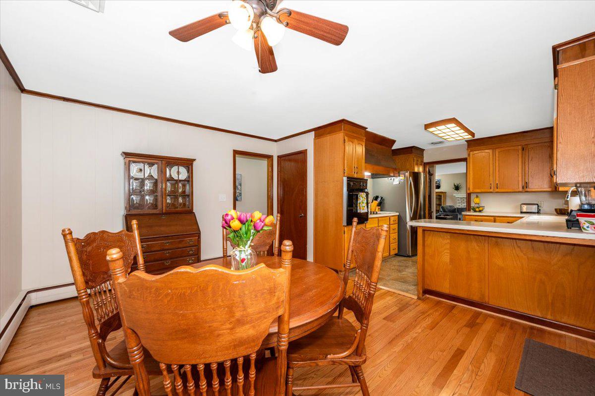 22019 Mohawk Drive Smithsburg, MD 21783 - Photo 21 of 60 a view of a dining room with furniture and wooden floor