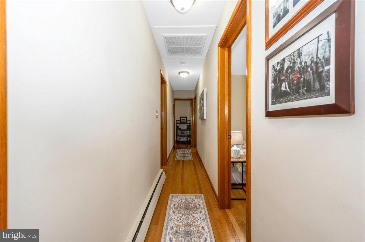 22019 Mohawk Drive Smithsburg, MD 21783 - Photo 22 of 60 a view of hallway with stairs and wooden floor