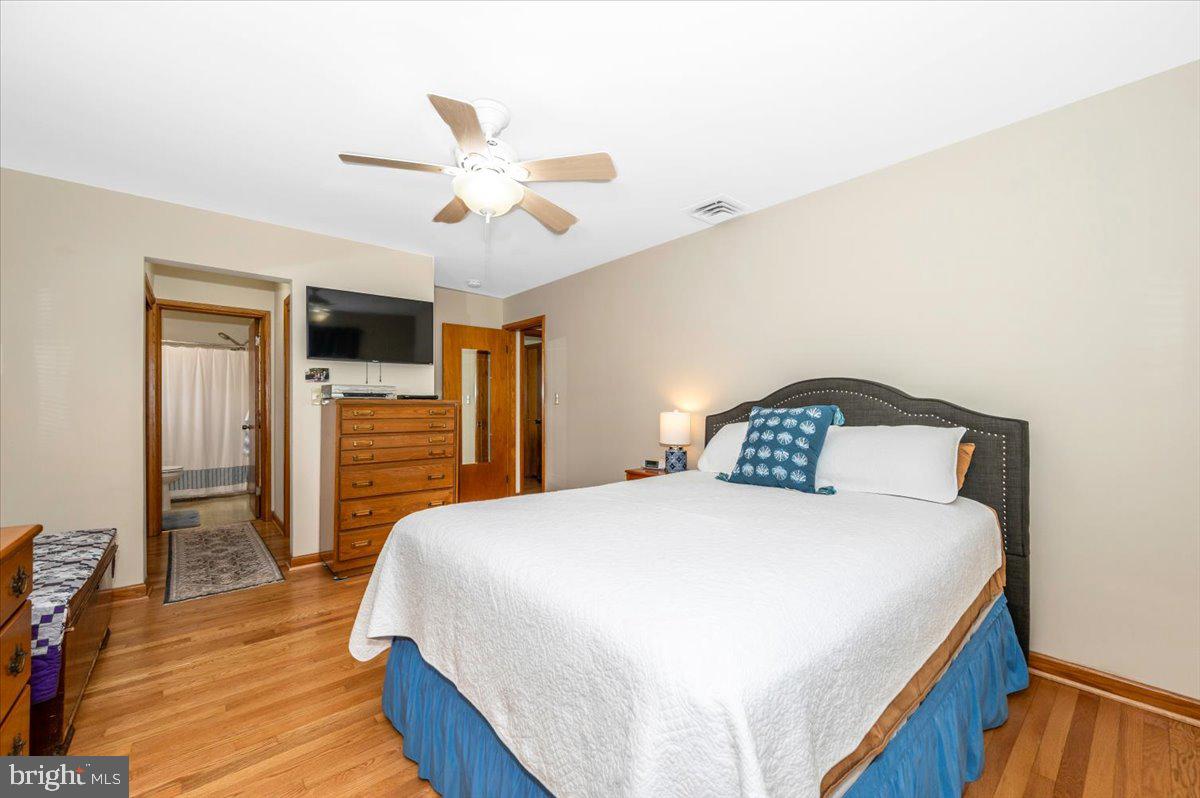 22019 Mohawk Drive Smithsburg, MD 21783 - Photo 26 of 60 a bedroom with a bed and a chandelier