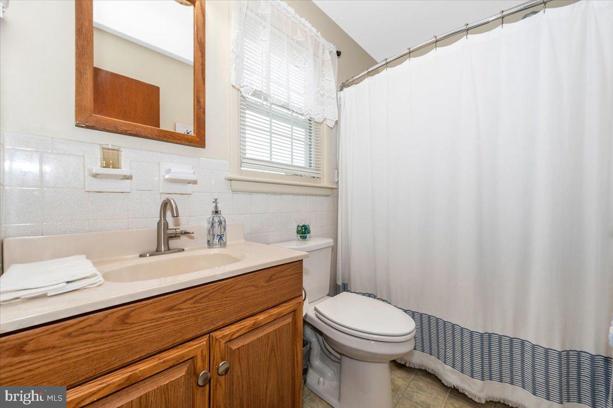 22019 Mohawk Drive Smithsburg, MD 21783 - Photo 28 of 60 a bathroom with a sink a toilet and mirror