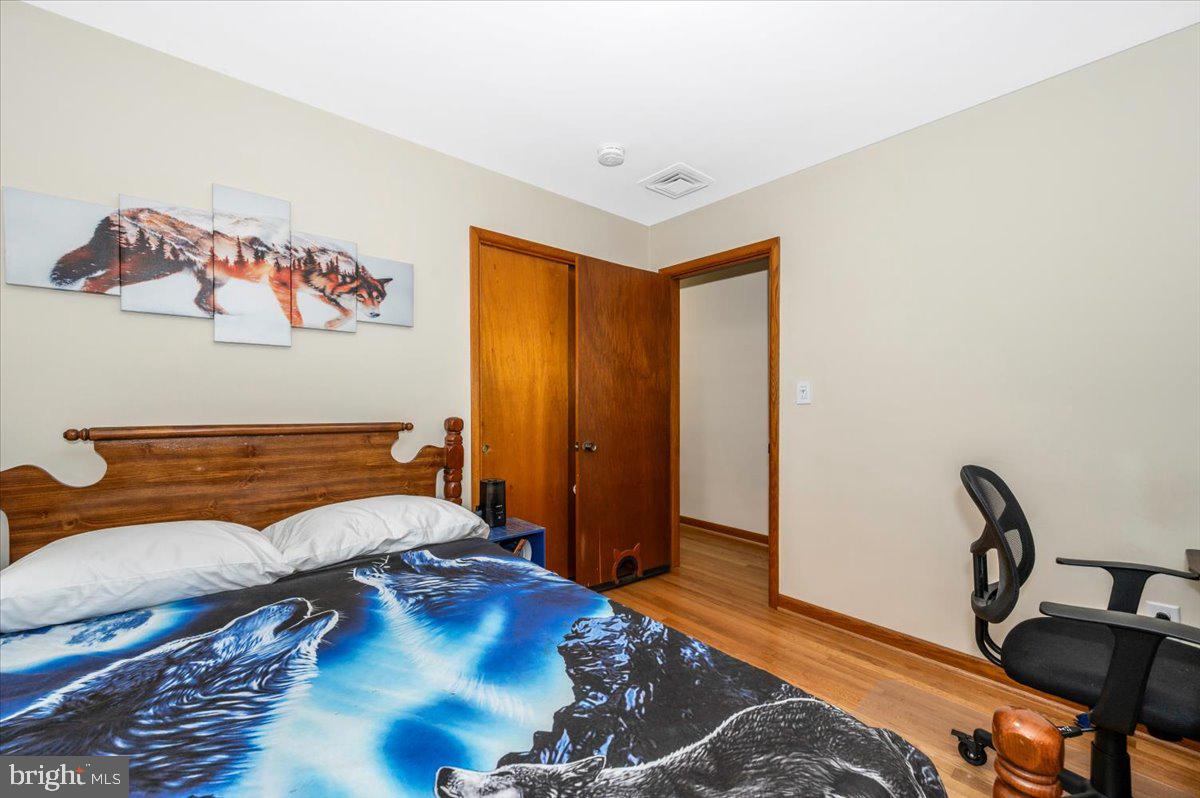 22019 Mohawk Drive Smithsburg, MD 21783 - Photo 32 of 60 a bedroom with a bed and wooden floor