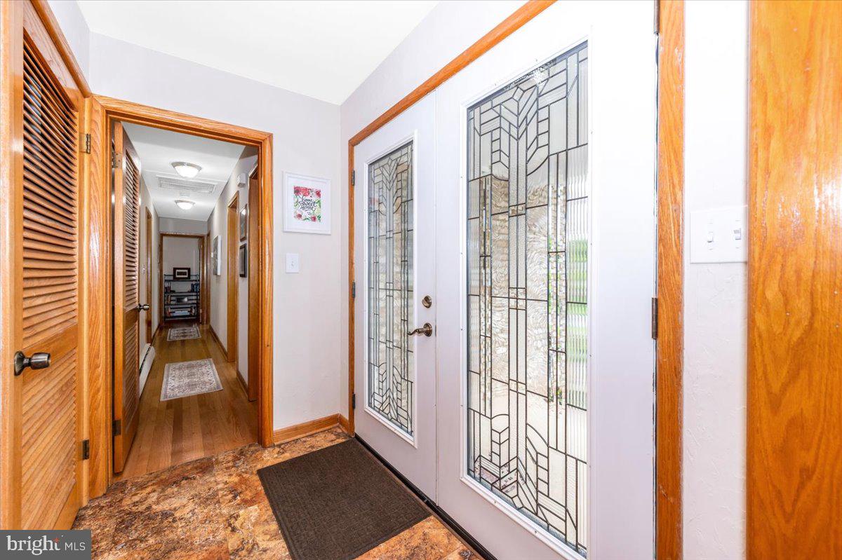 22019 Mohawk Drive Smithsburg, MD 21783 - Photo 4 of 60 a view of a hallway with wooden floor and windows
