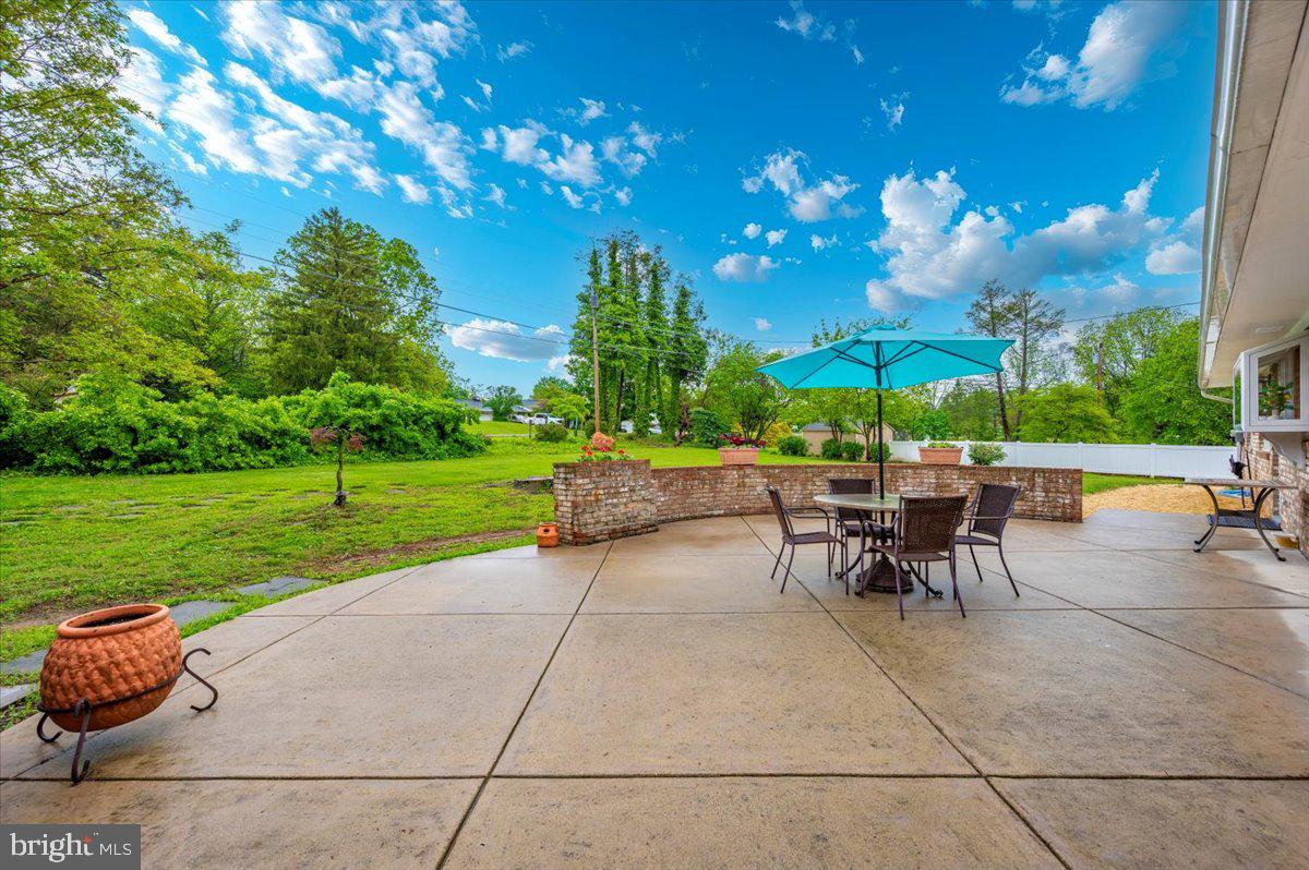 22019 Mohawk Drive Smithsburg, MD 21783 - Photo 49 of 60 a view of a patio with a dining table and chairs with a fire pit