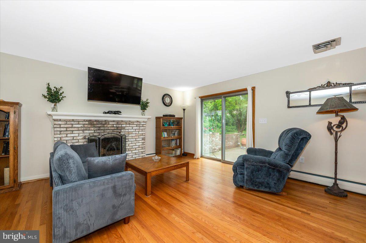 22019 Mohawk Drive Smithsburg, MD 21783 - Photo 7 of 60 a living room with furniture a flat screen tv and a fireplace