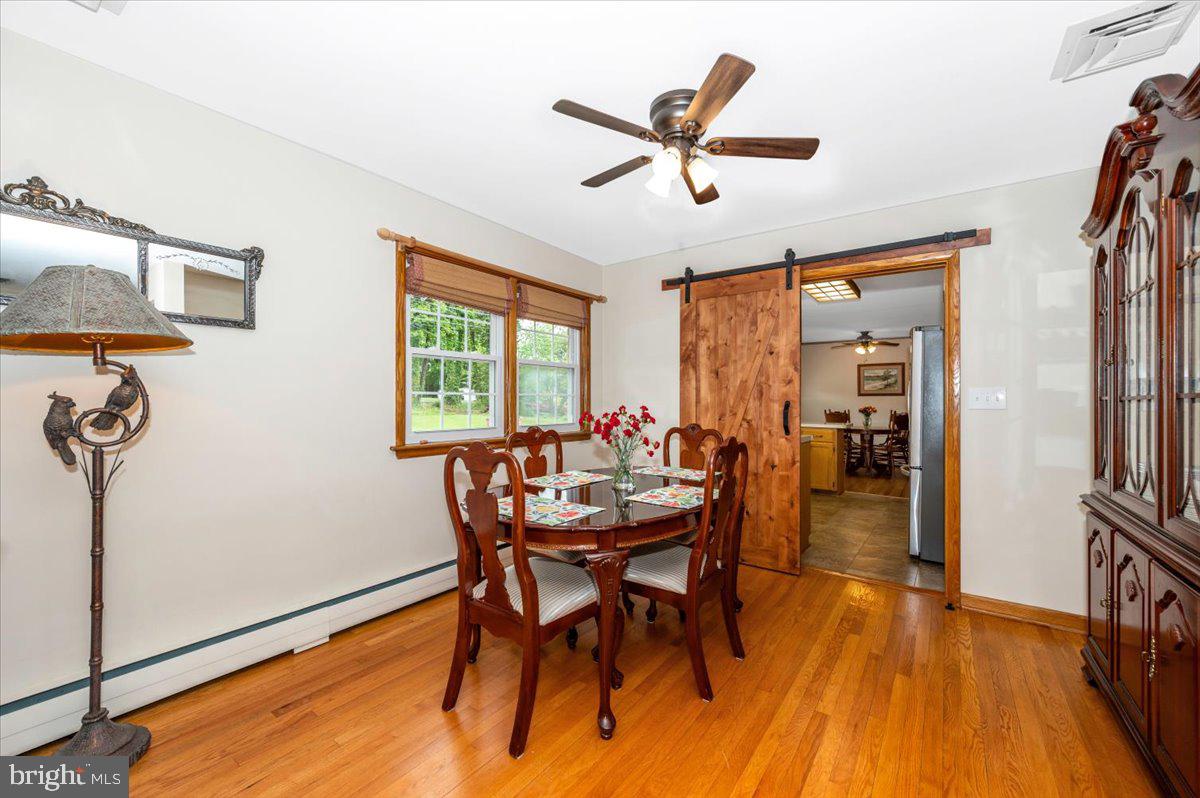 22019 Mohawk Drive Smithsburg, MD 21783 - Photo 10 of 60 a view of a dining room with furniture window and wooden floor