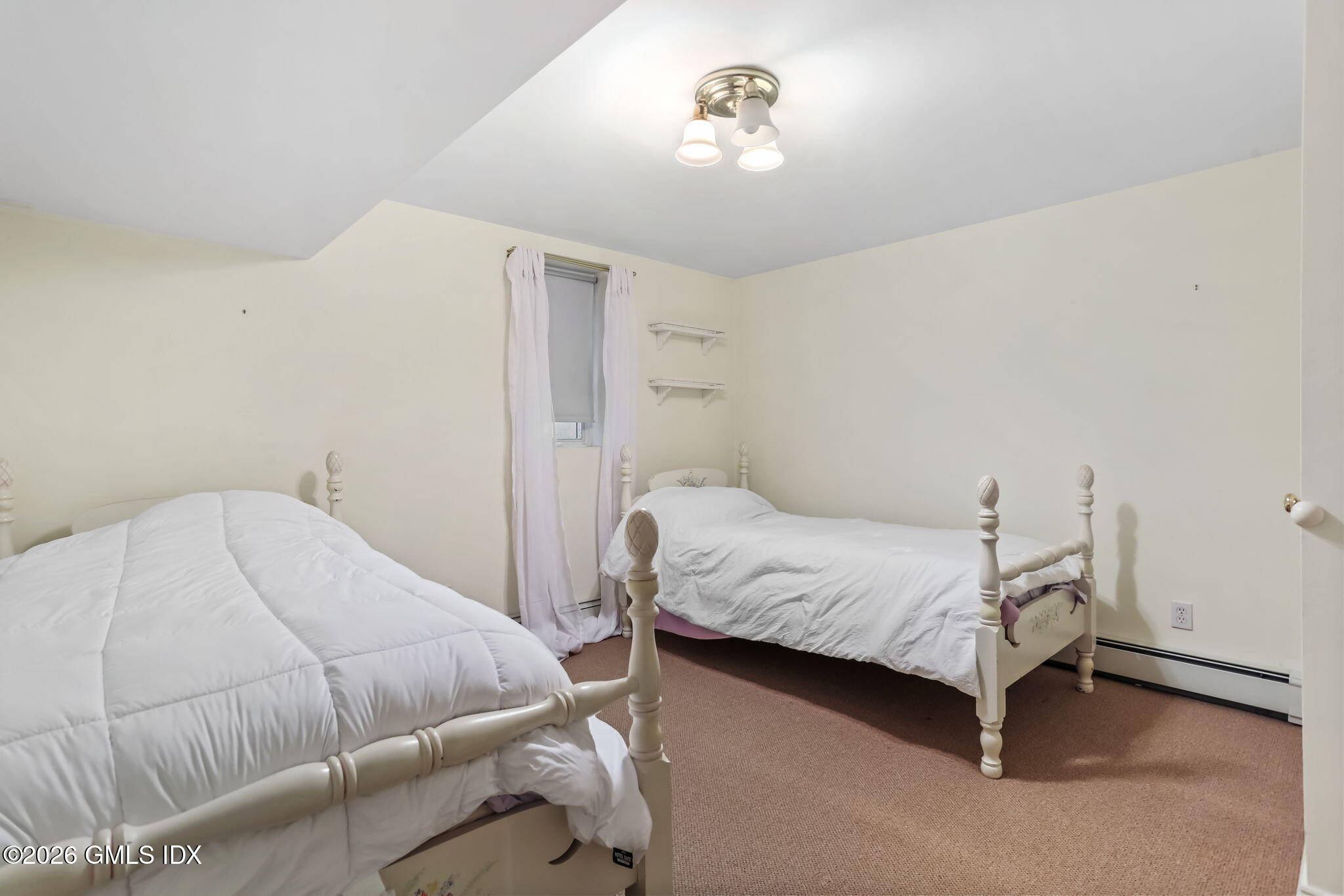 153 Lockwood Road Riverside, CT 06878 - Photo 43 of 58 a bedroom with a bed and a chandelier