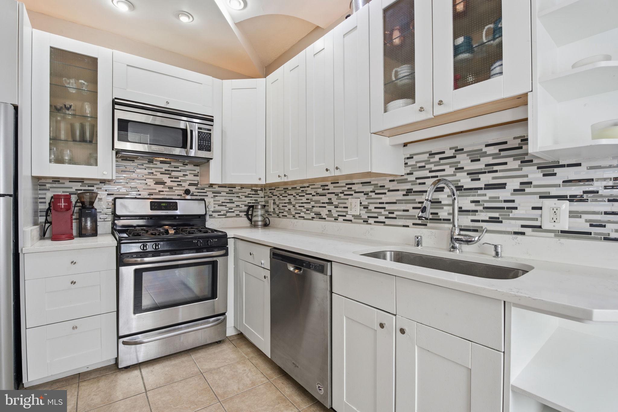 116 West Clement Street Baltimore, MD 21230 - Photo 13 of 32 a kitchen with granite countertop a sink stove and microwave