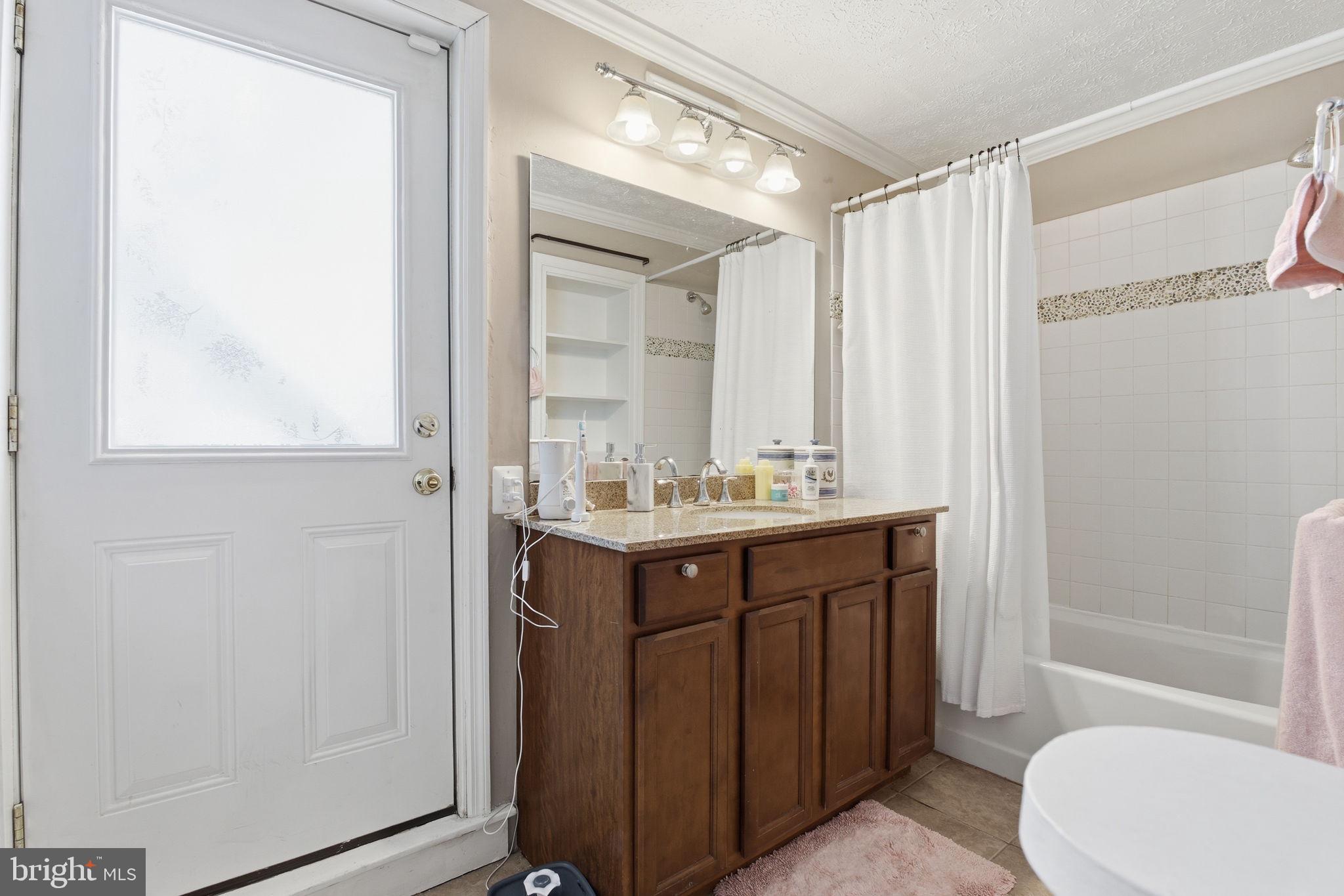 116 West Clement Street Baltimore, MD 21230 - Photo 20 of 32 a bathroom with a sink a toilet and shower