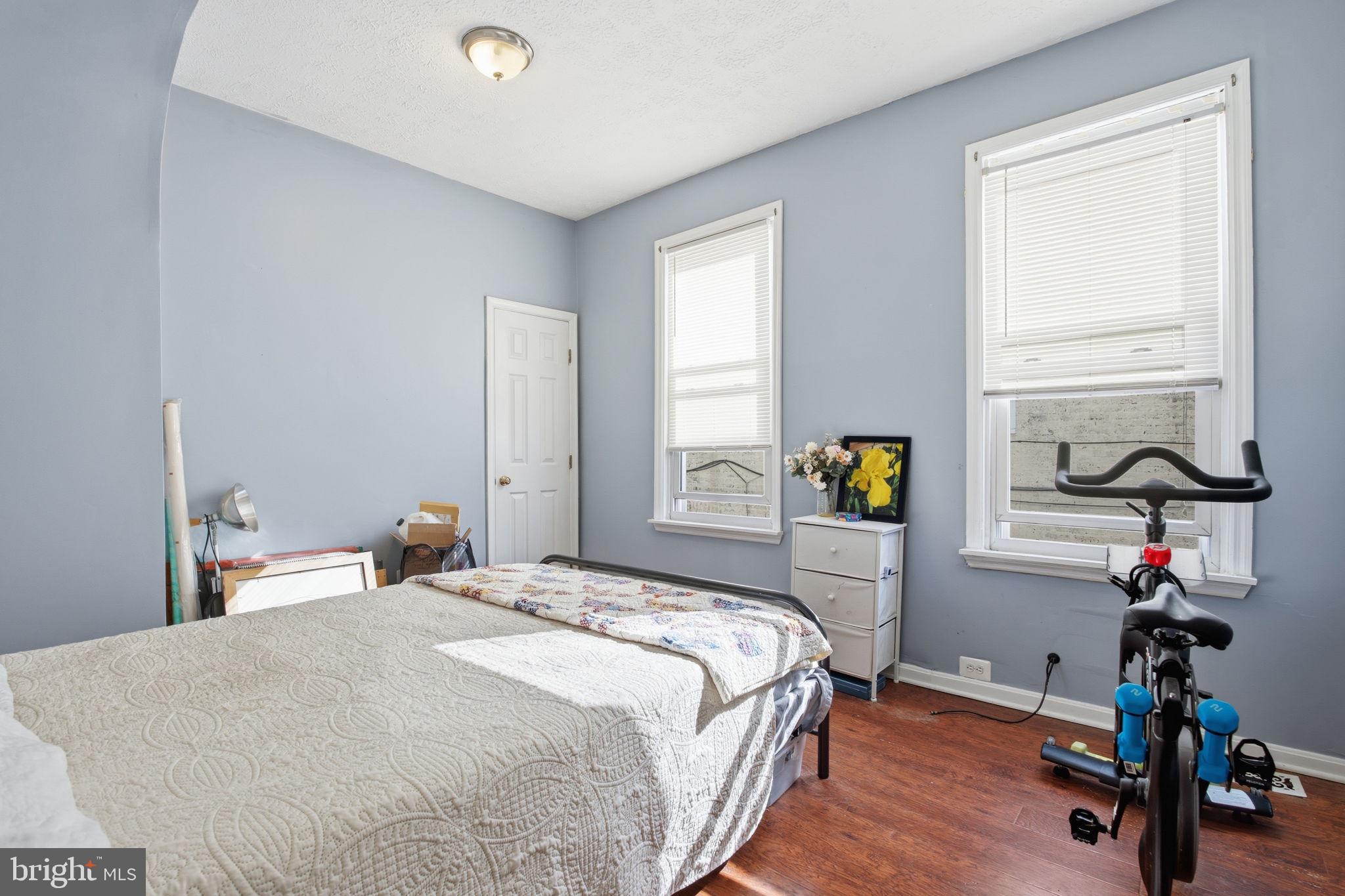 116 West Clement Street Baltimore, MD 21230 - Photo 21 of 32 a bedroom with a bed and a wooden floor