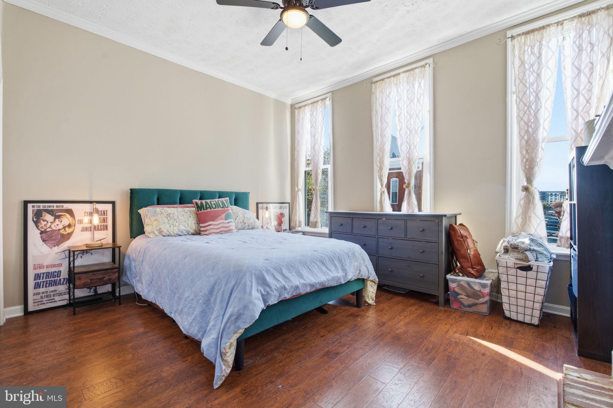 116 West Clement Street Baltimore, MD 21230 - Photo 24 of 32 a bedroom with a bed and a chandelier