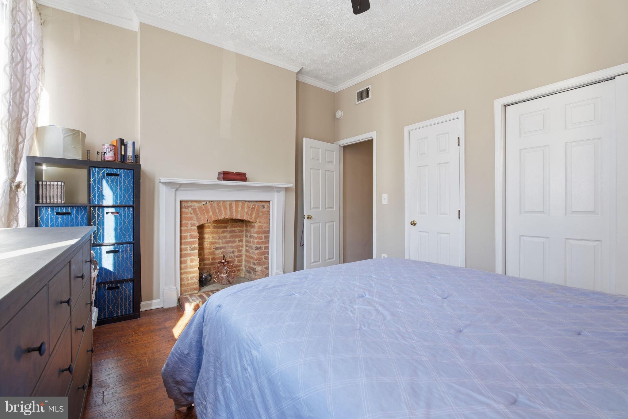 116 West Clement Street Baltimore, MD 21230 - Photo 27 of 32 a bedroom with a bed and a fireplace