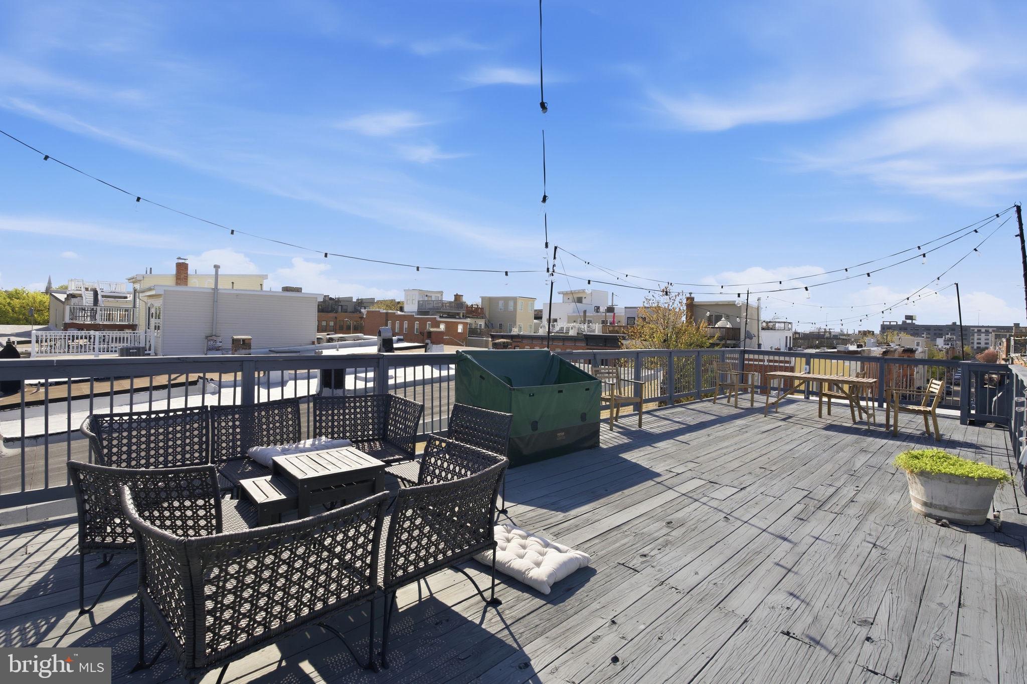 116 West Clement Street Baltimore, MD 21230 - Photo 29 of 32 a view of a roof deck with dining table and chairs