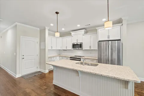 a kitchen with a stove a sink and a refrigerator