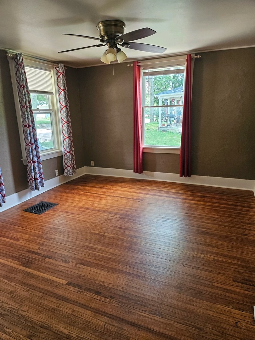 416 Madison Avenue Dixon, IL 61021 - Photo 6 of 34 a view of an empty room with wooden floor and a window