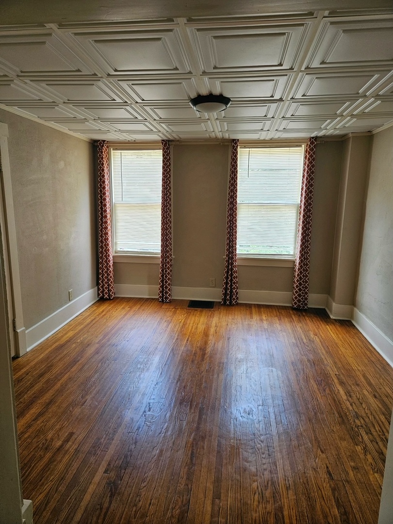 416 Madison Avenue Dixon, IL 61021 - Photo 7 of 34 an empty room with wooden floor and windows