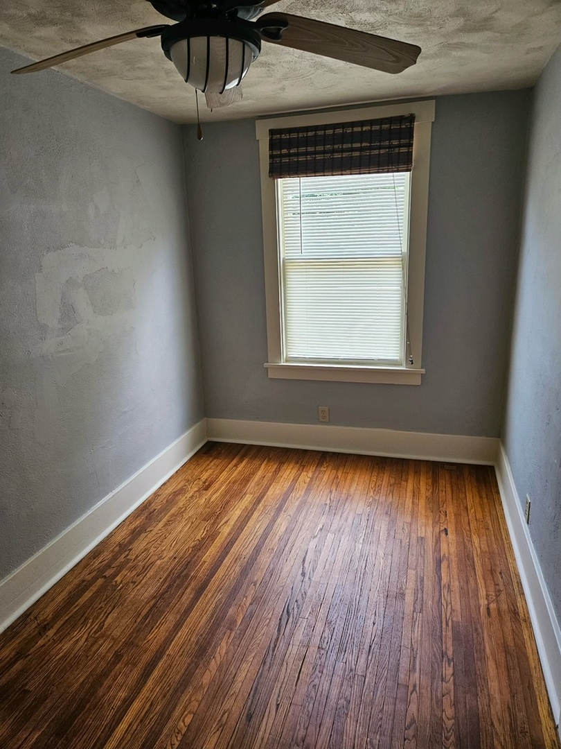 416 Madison Avenue Dixon, IL 61021 - Photo 8 of 34 a view of an empty room with wooden floor and a window