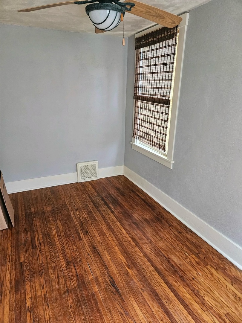 416 Madison Avenue Dixon, IL 61021 - Photo 9 of 34 a view of a room with wooden floor and a window